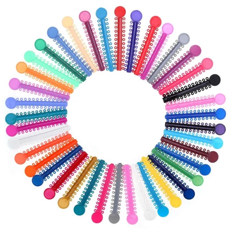 Colorful orthodontic elastic ligature ties arranged in a circle