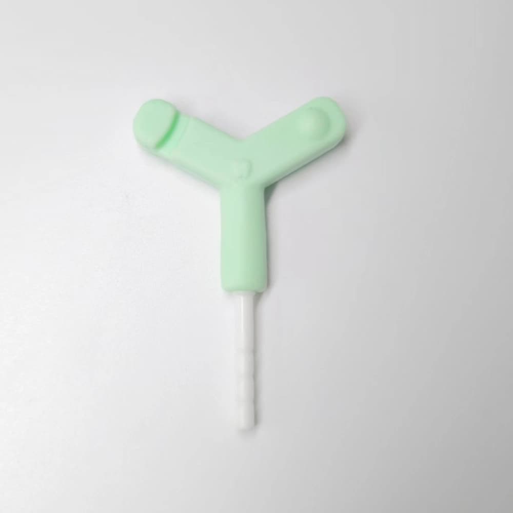 Green Y-shaped silicone aligner chewie with a white PP extension rod