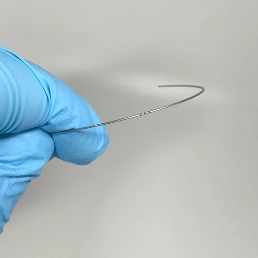Copper NiTi orthodontic archwire with a visible centerline mark