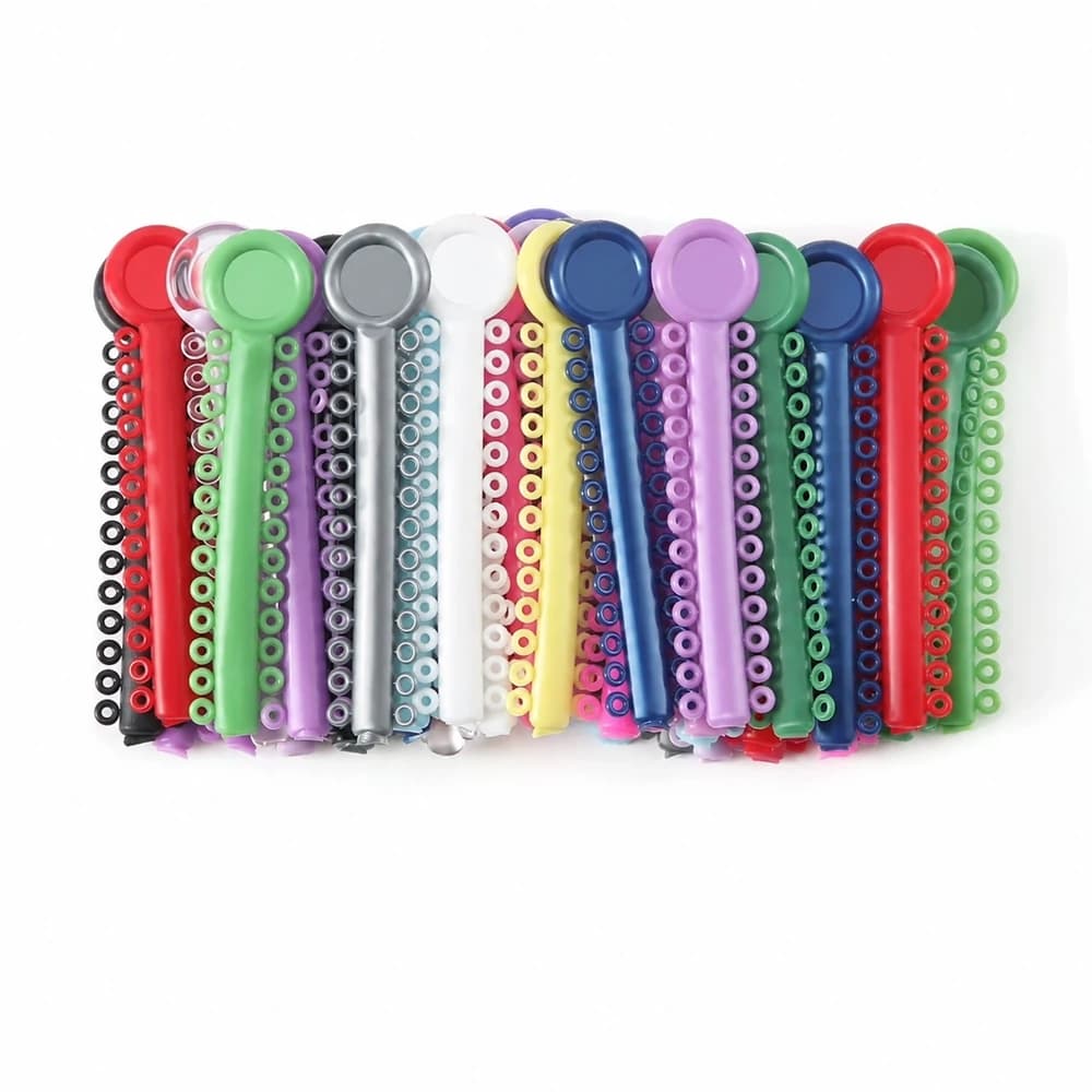 Multicolor orthodontic elastic ligature ties arranged on carrier strips