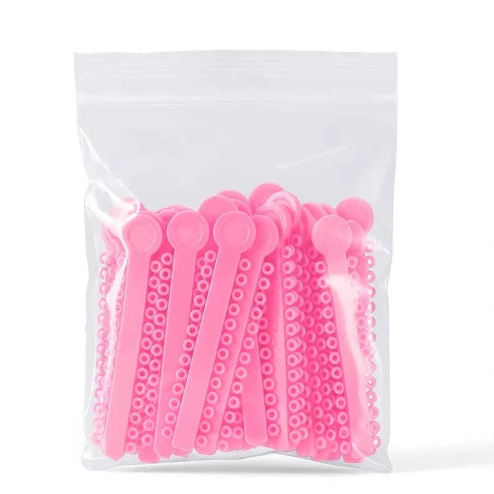 Pink orthodontic ligature ties packed as 40 strips and 1040 ties per bag