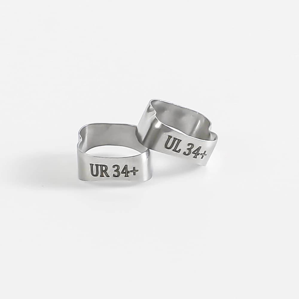 Two polished plain molar bands with visible UR 34 plus and UL 34 plus markings