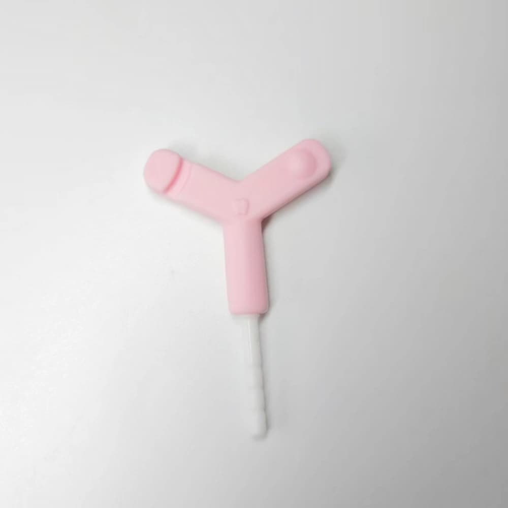 Pink Y-shaped silicone aligner chewie with a white PP extension rod