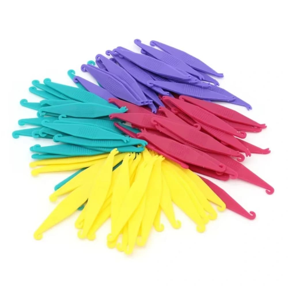 Random mixed-color orthodontic elastic placers in purple, teal, pink and yellow
