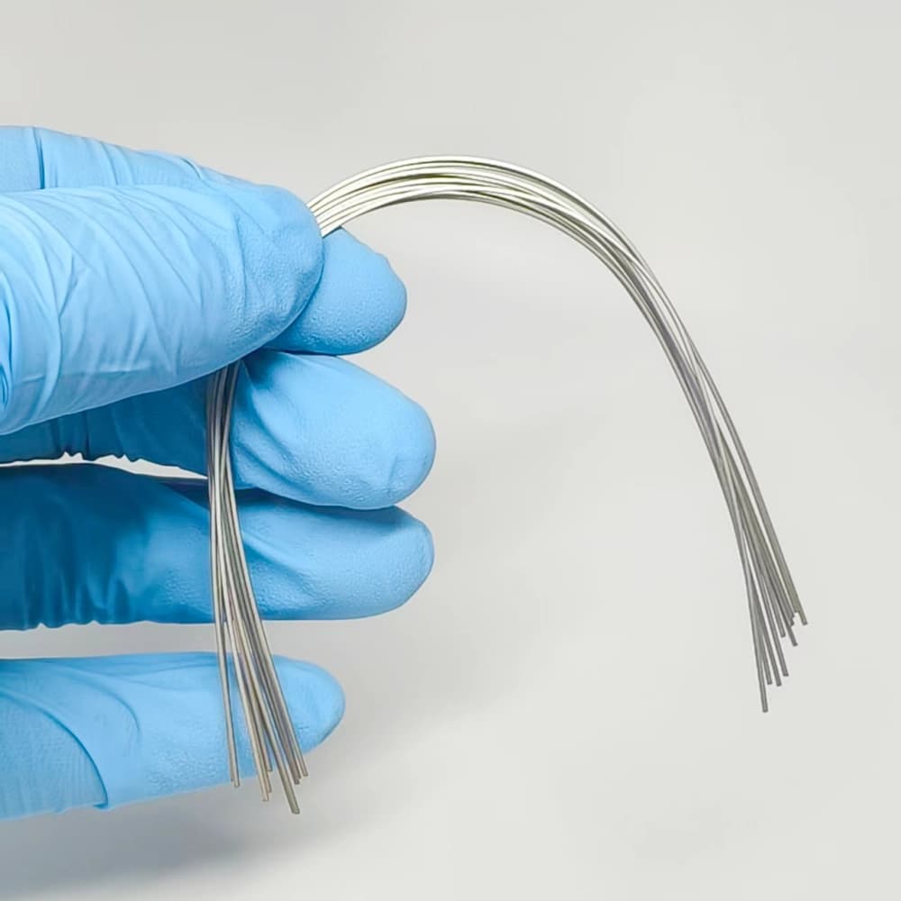 Multiple superelastic NiTi archwires shown in a curved configuration