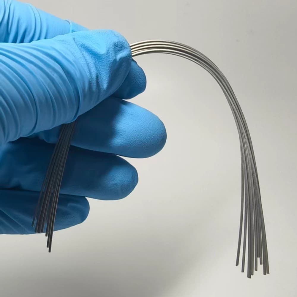 Polished heat-activated nickel-titanium orthodontic archwires in a curved configuration